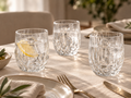 Faceted glass tumblers styled on a dining table with iced drinks